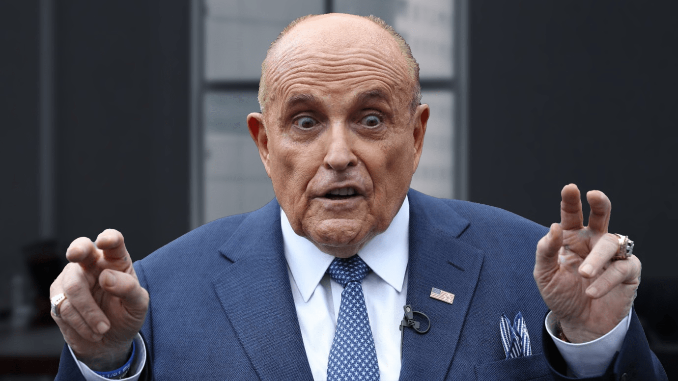 The person slapping Rudy Giuliani on his back is in custody, police say